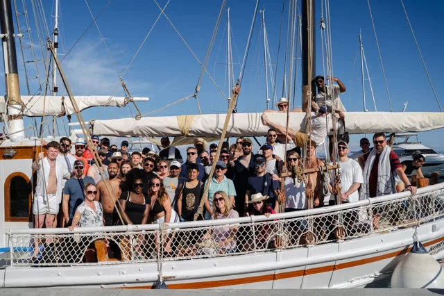 The Novello team gathered on the deck of a traditional sailing boat during the company trip to Corfu